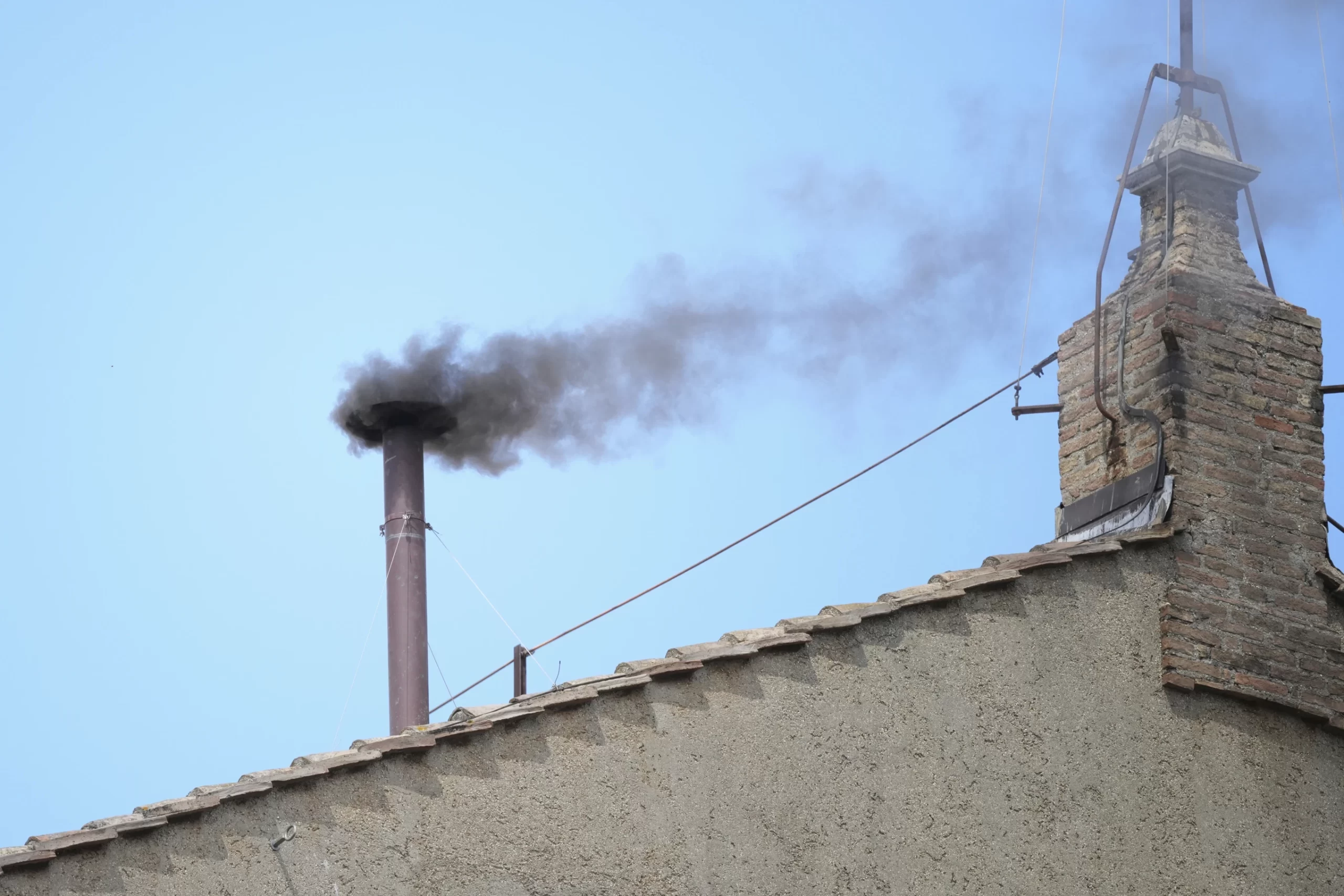 Thick black smoke from the Sistine Chapel chimney during papal conclave in Vatican City, 2025