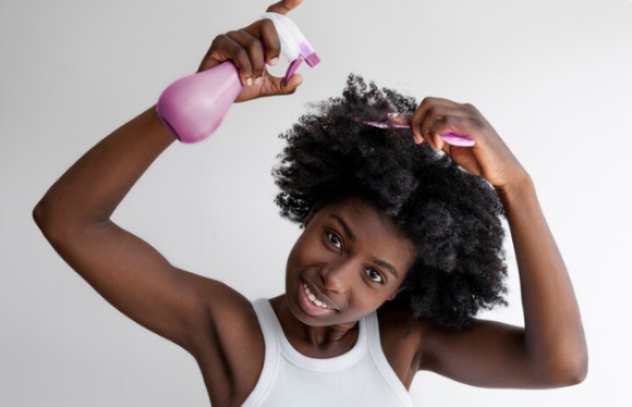 Using a spray bottle to moisturize and gently detangle natural 4C hair-a key step in preserving length and maintaining healthy 4C hair