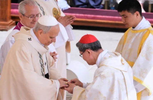 Pope Leo XIV receives the Ring of the Fisherman from a cardinal during his inauguration ceremony at St. Peter’s Basilica.