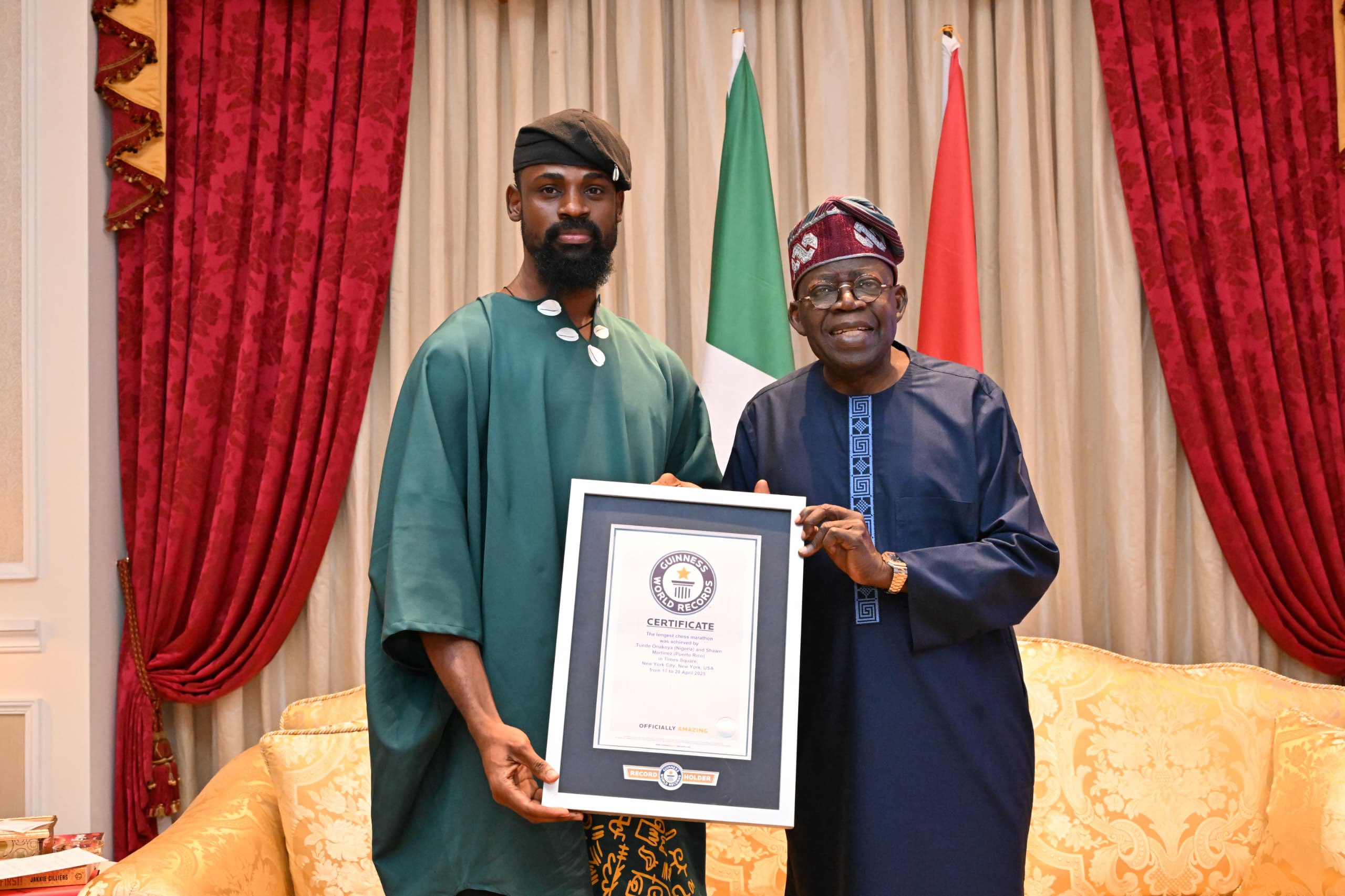 Tunde Onakoya presenting his Guinness World Record certificate to President Bola Tinubu in Lagos.