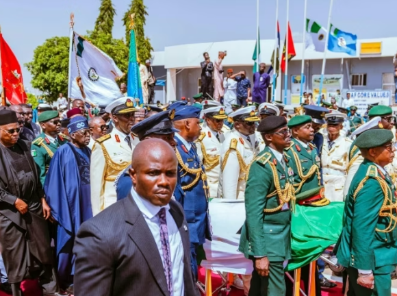 President Bola Tinubu joins a solemn procession as military pallbearers carry the casket of former President Muhammadu Buhari at Katsina airport.
